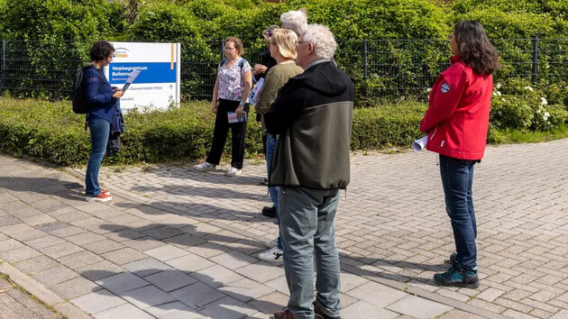 Groep mensen staat voor een bord van een verpleegcentrum.